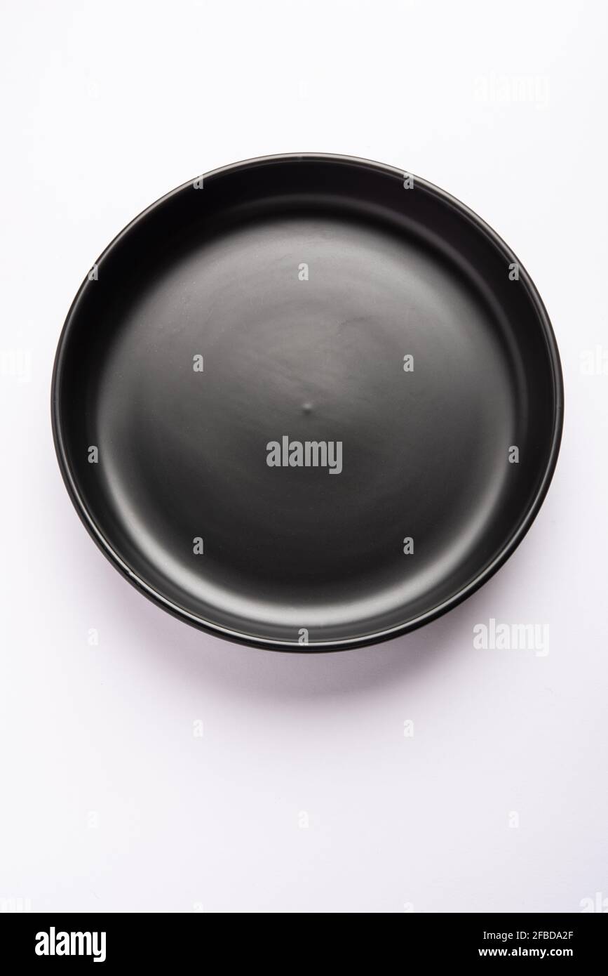 Empty black ceramic serving bowl, isolated over white or gray background Stock Photo