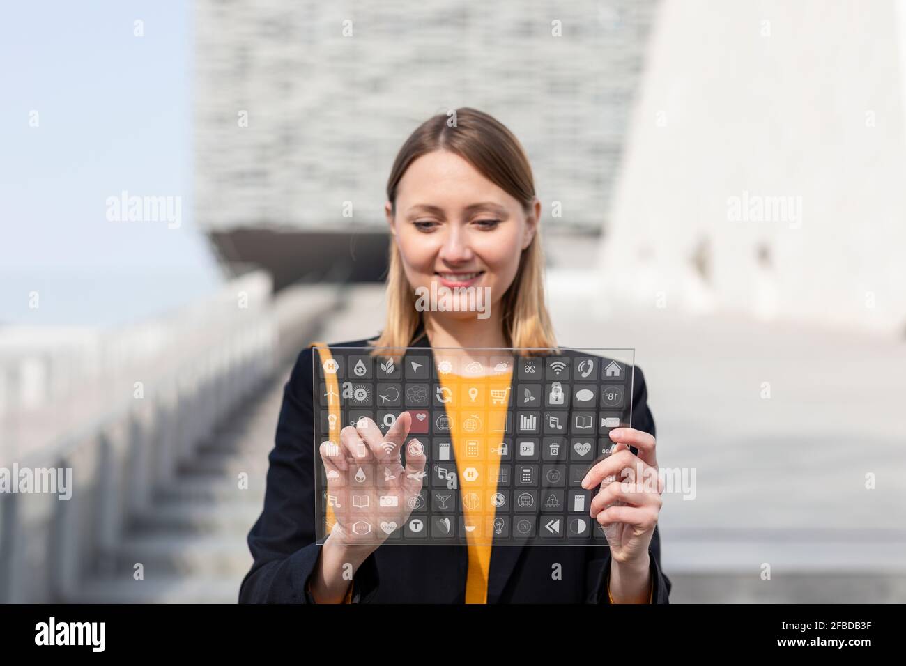 Smiling entrepreneur using futuristic digital tablet outdoors Stock Photo