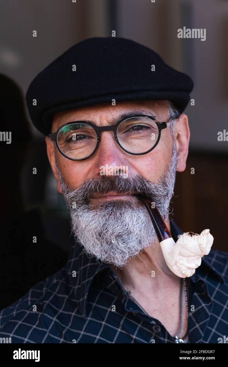 Bearded mature man smoking pipe Stock Photo