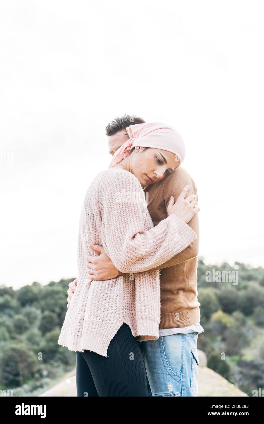Woman with bandana embracing her boyfriend Stock Photo