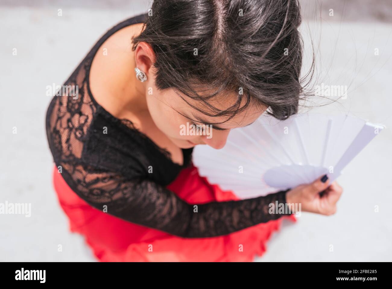 Female flamenco dancer with hand fan practicing dance Stock Photo