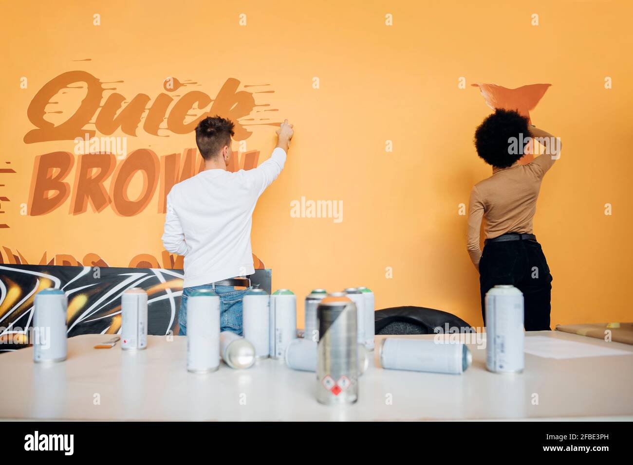 Woman spray painting wall hi-res stock photography and images - Alamy
