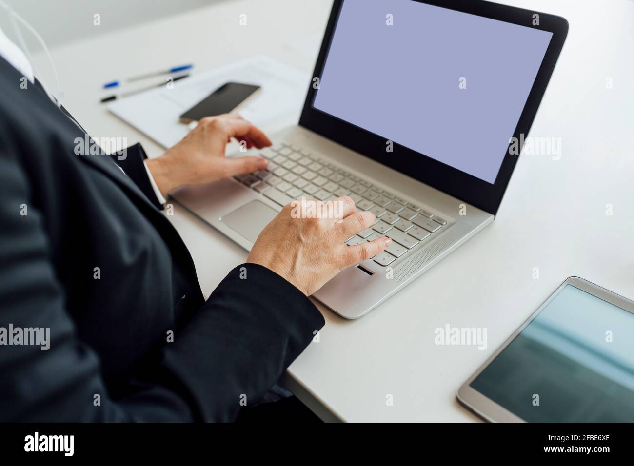Mature woman desk typing laptop hi-res stock photography and images - Alamy