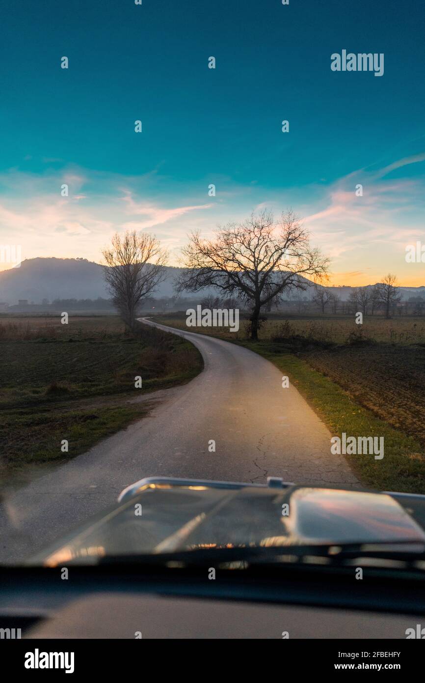 Car on country road at sunset hi-res stock photography and images - Alamy