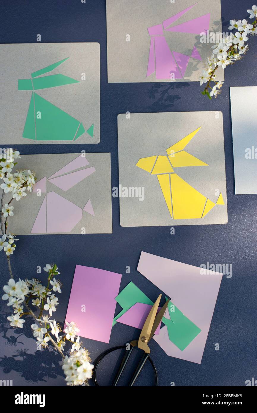 Blossoms and pastel colored rabbits cut from cardboard Stock Photo - Alamy