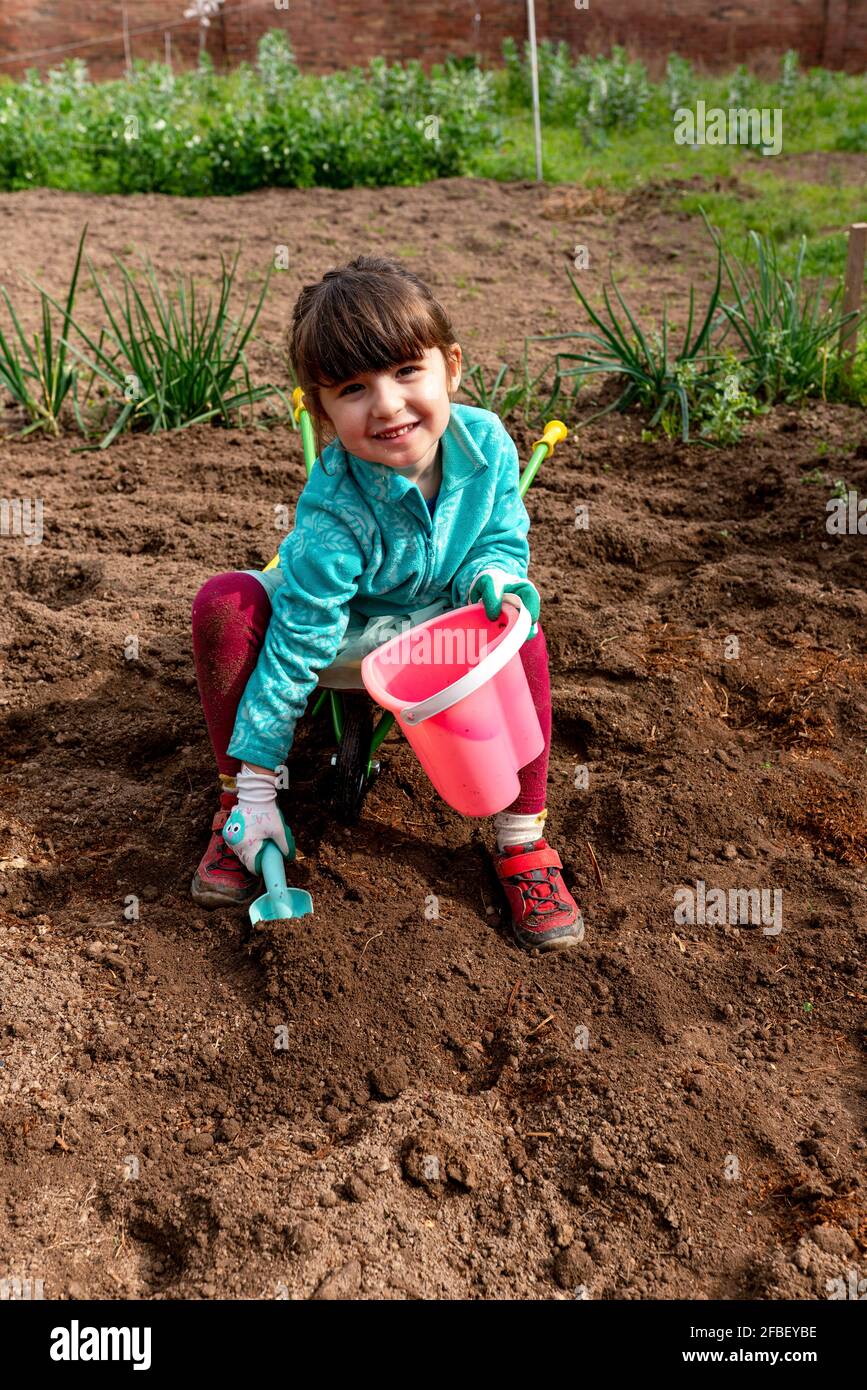 Girl Sitting In Wheelbarrow High Resolution Stock Photography and ...