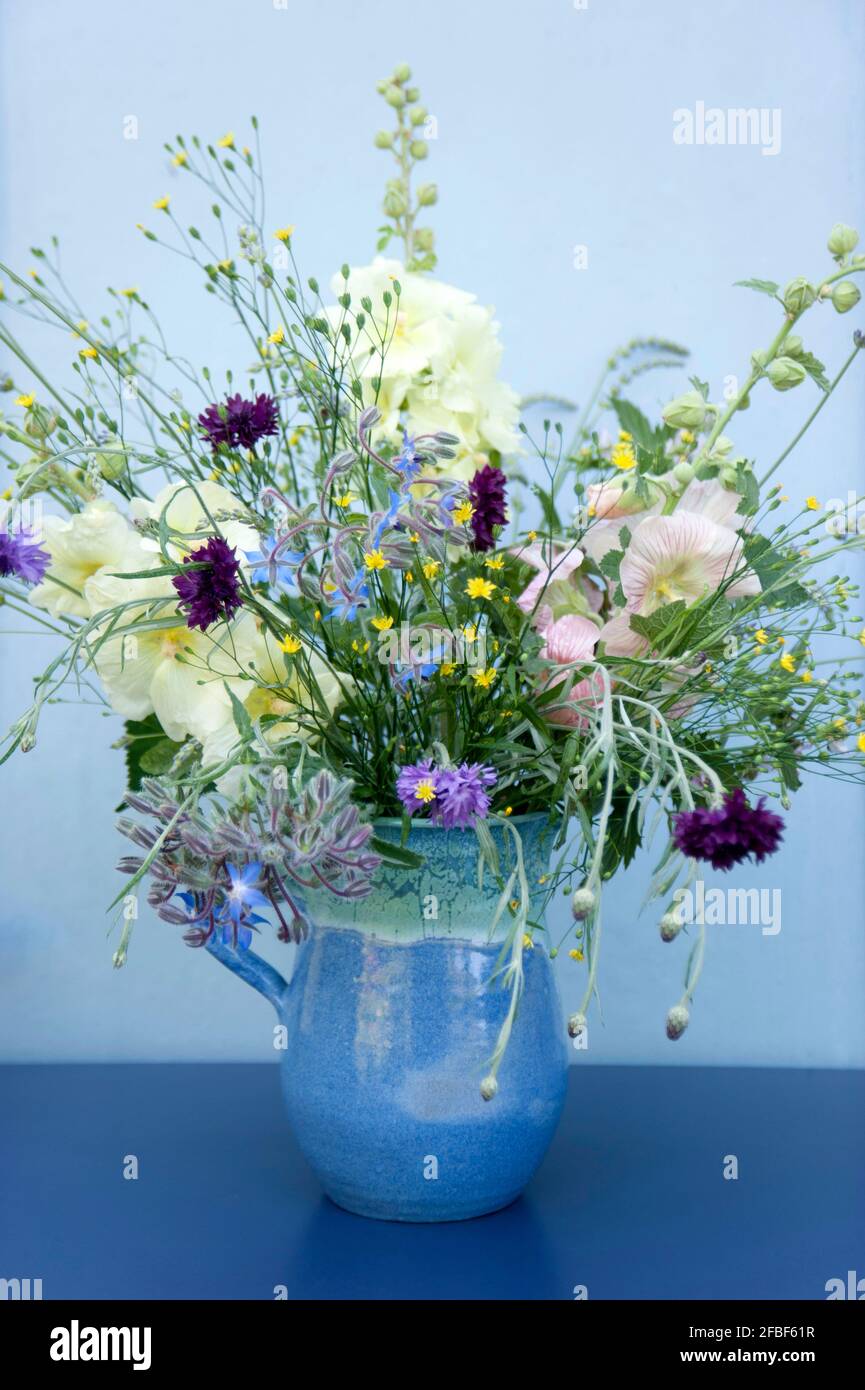 Summer flowers in blue jug Stock Photo