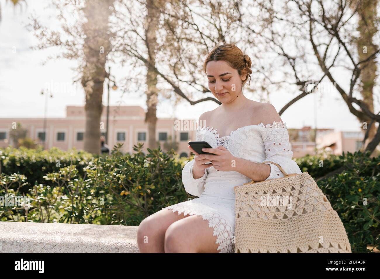 Woman in white dress sitting hi-res stock photography and images - Alamy