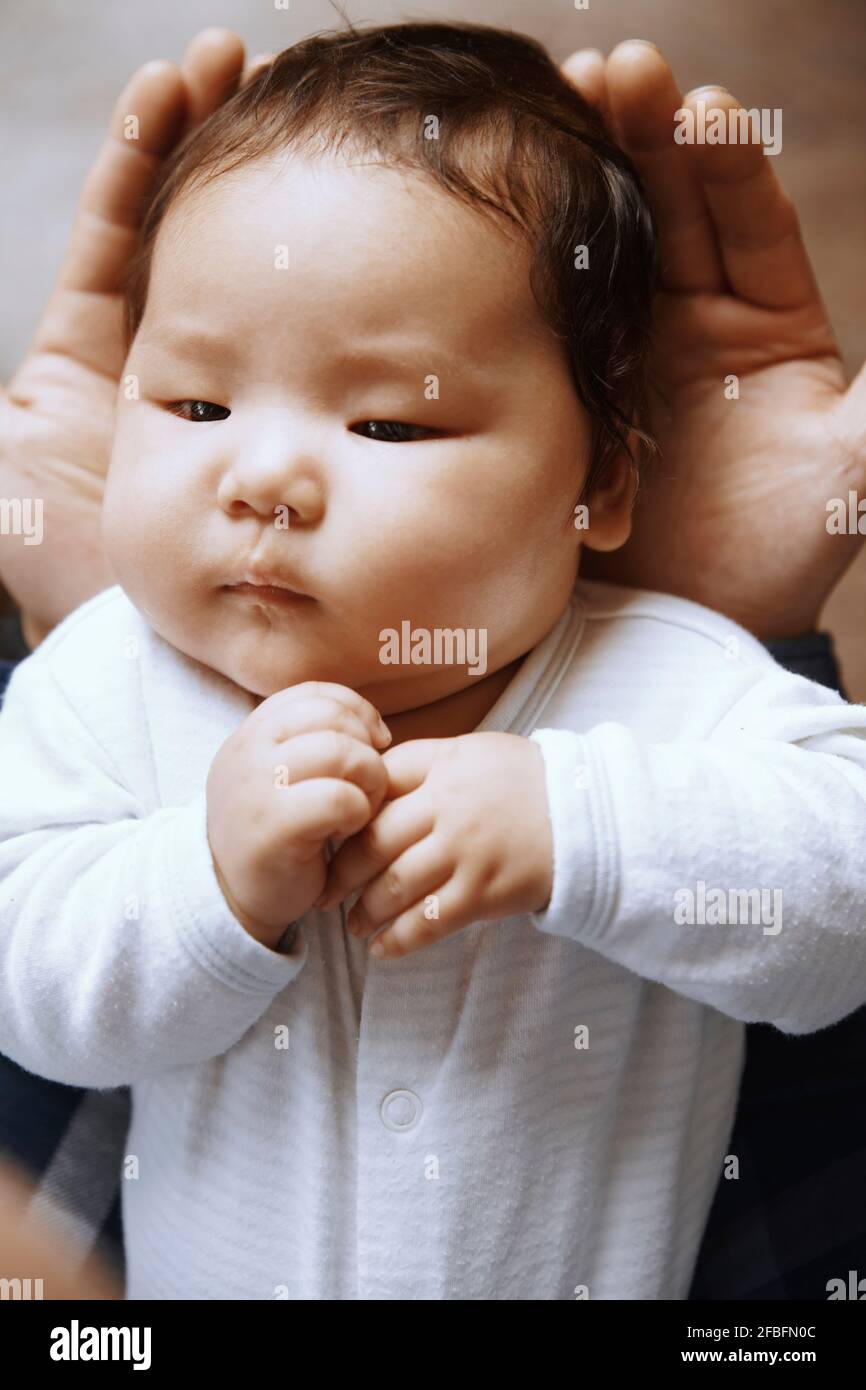 Newborn child laying on the fathers hands Stock Photo