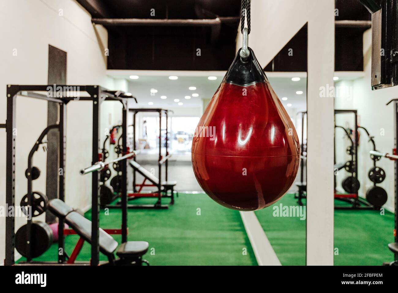 Red punching bag hanging in gym Stock Photo Alamy