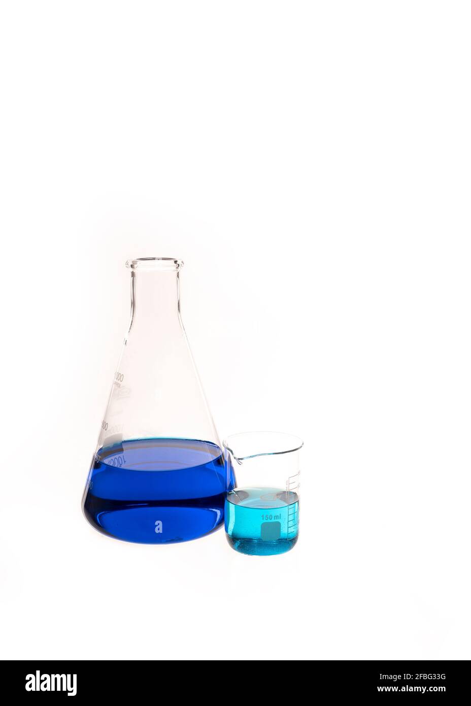 Conical flat flask and Berzelius Beaker filled with colorful blue and teal liquid. Chemistry research and lab instruments with copy space available Stock Photo