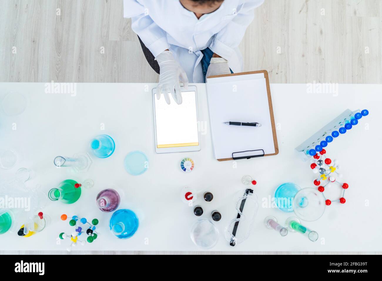 Researcher working on digital tablet on table in laboratory Stock Photo