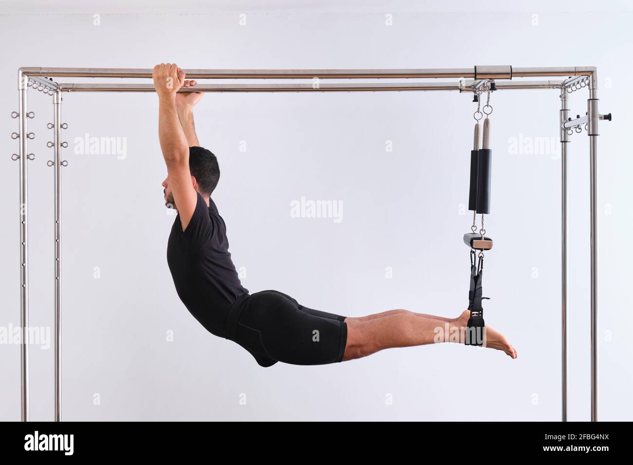 Woman performing Pilates exercise using a Cadillac or Trapeze table Stock  Photo - Alamy