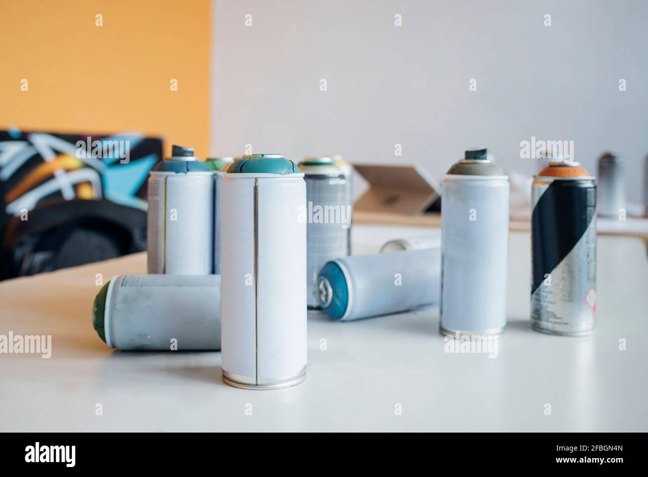 Aerosol spray paint can on table in studio Stock Photo
