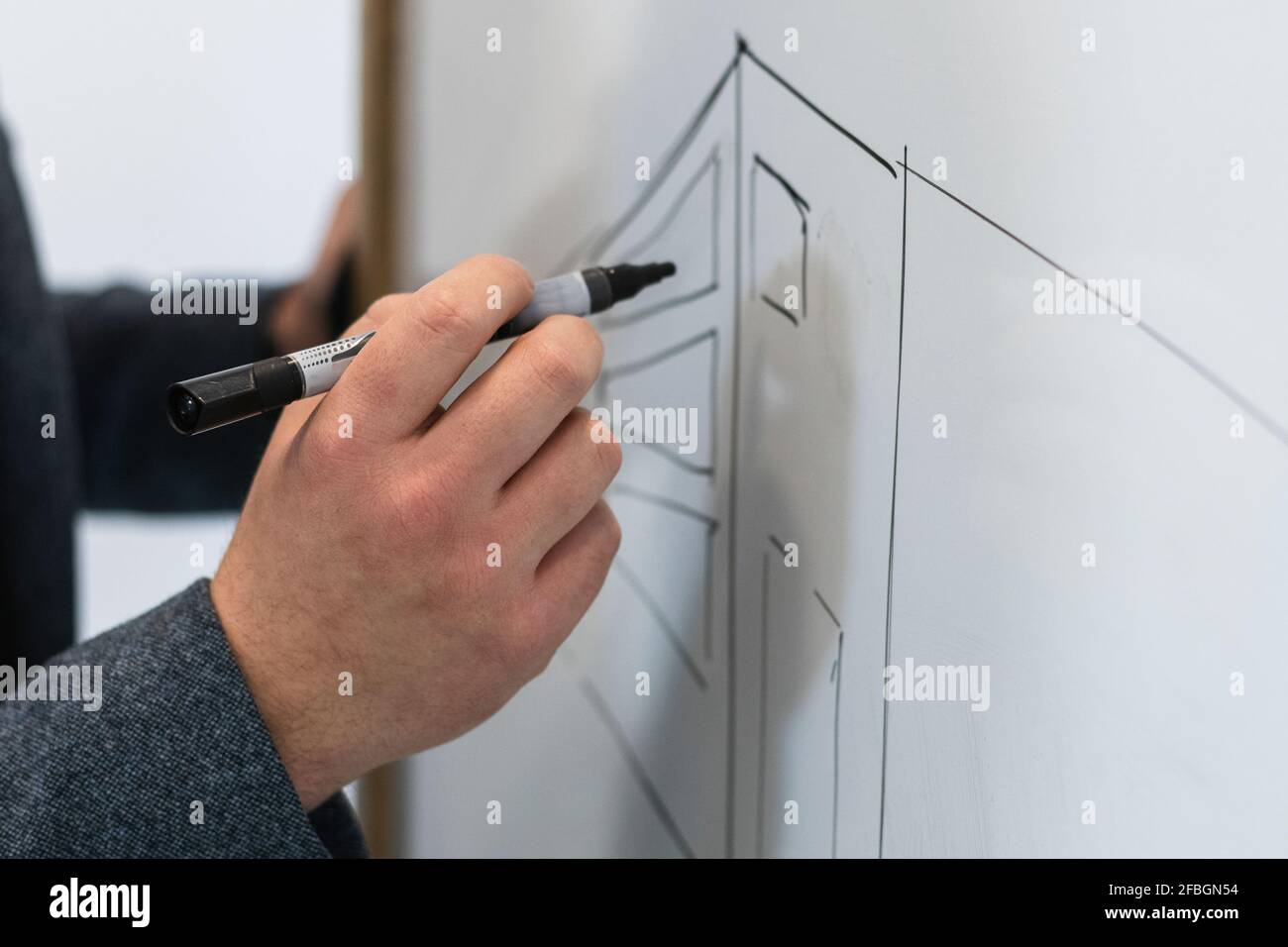 Businessman drawing diagram on whiteboard Stock Photo