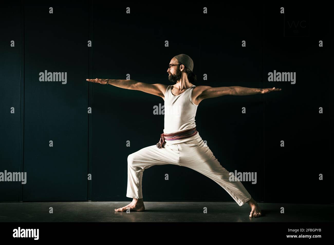 Male yoga instructor practicing with arms outstretched Stock Photo Alamy