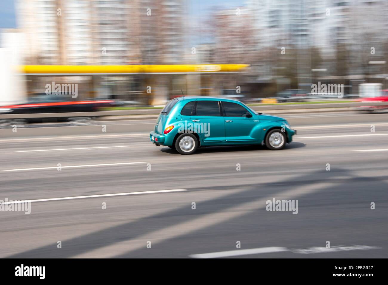 Ukraine, Kyiv - 6 April 2021: Light Blue Chrysler PT Cruiser car moving on the street. Editorial Stock Photo