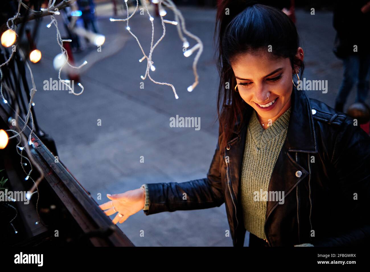 Smiling young woman spending leisure time in city Stock Photo