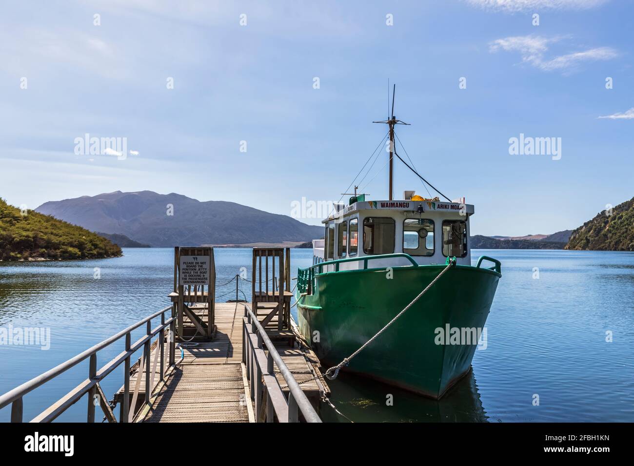 Fishboat moored by wooden pier Stock Photo