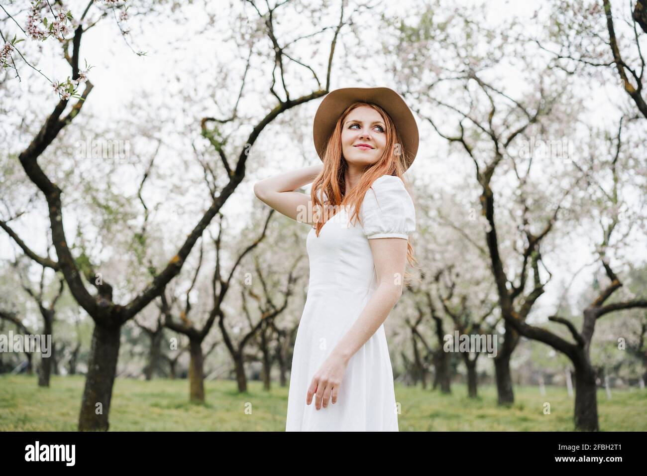 Smiling woman standing in park hi-res stock photography and images - Alamy