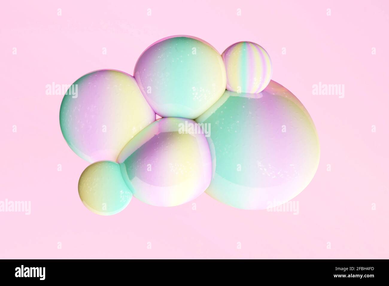 Yellow, green and pink pastel bubbles against pink background Stock Photo