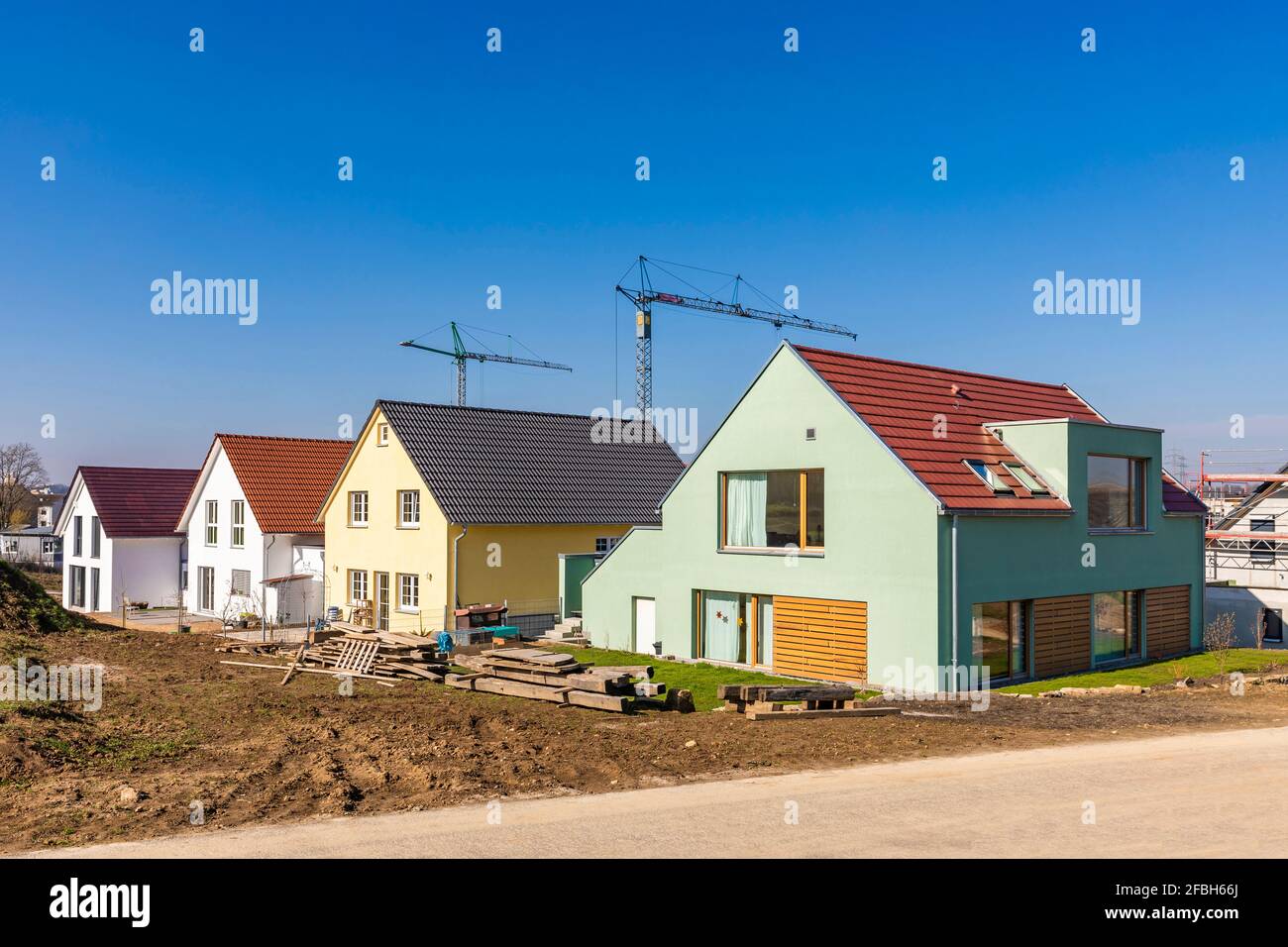 Germany, Baden-Wurttemberg, Ludwigsburg, Clear sky over new modern development area with industrial cranes in background Stock Photo