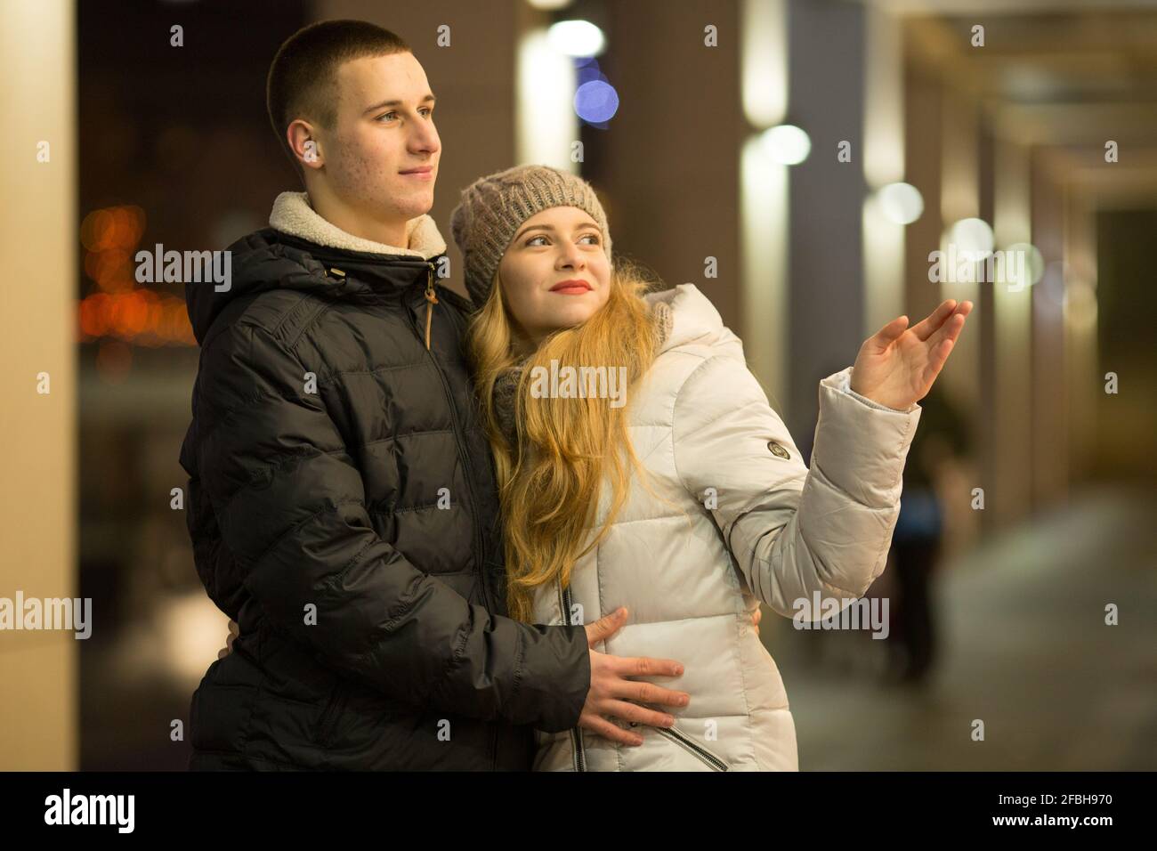 Dnepropetrovsk, Ukraine - 09.12.2016: A couple of young people in front of an expensive store window. Stock Photo
