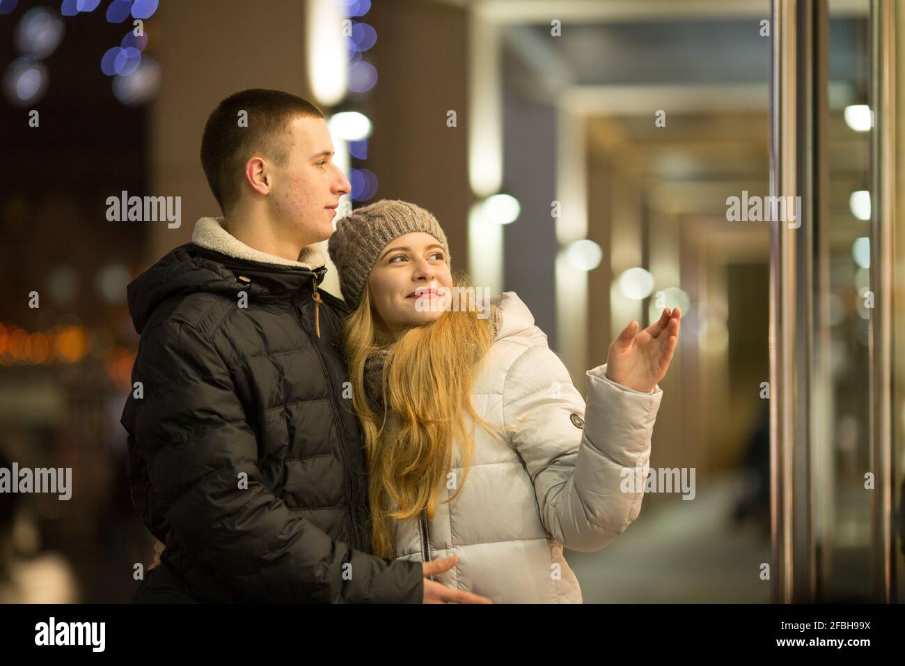 Dnepropetrovsk, Ukraine - 09.12.2016: A couple of young people in front of an expensive store window. Stock Photo