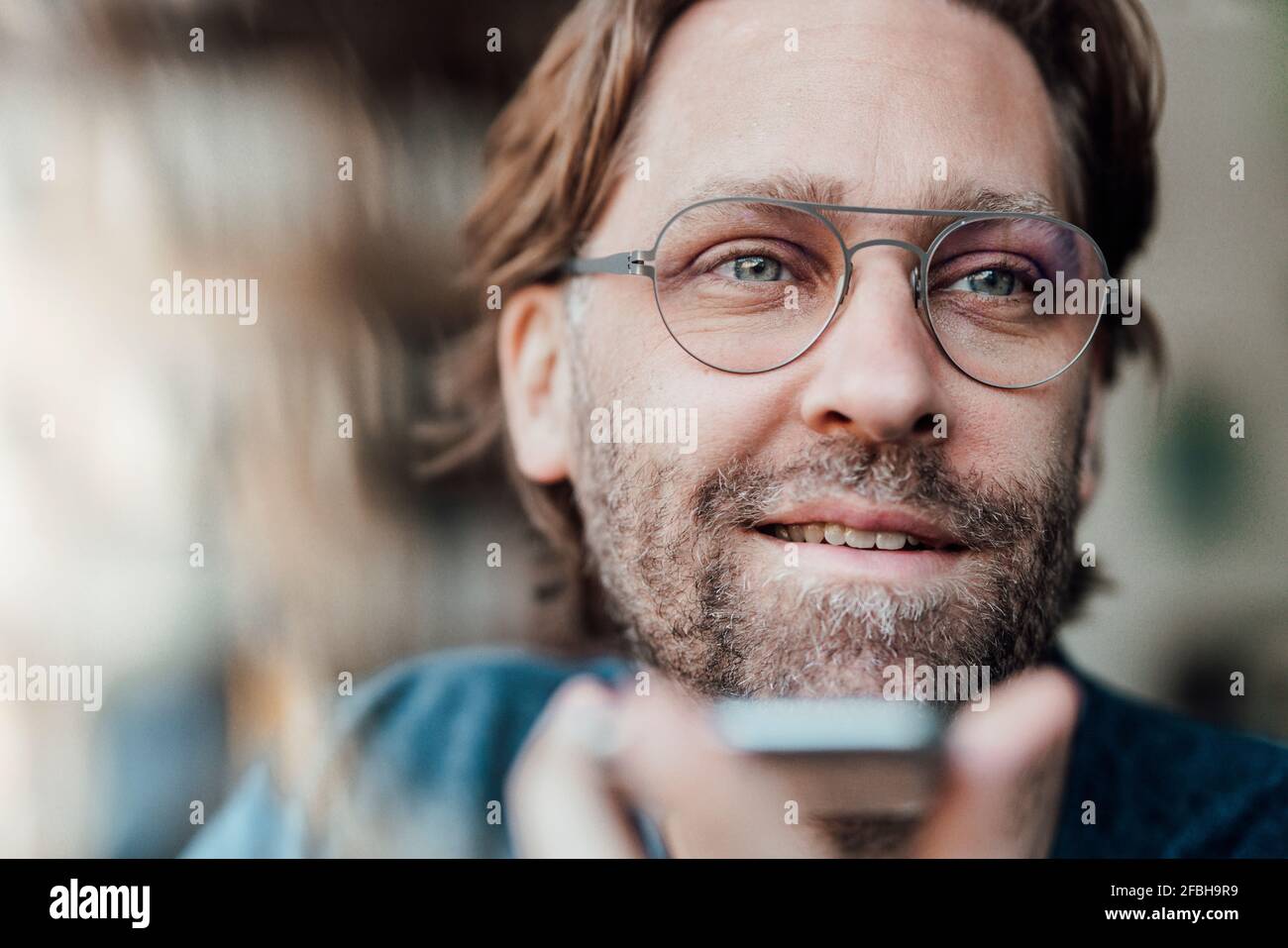 Smiling man looking away at cafe Stock Photo
