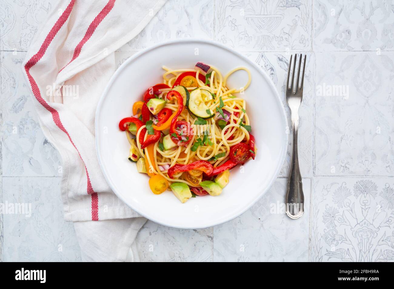 Spaghetti with grilled vegetables, paprika, zucchini, avocado, tomato
