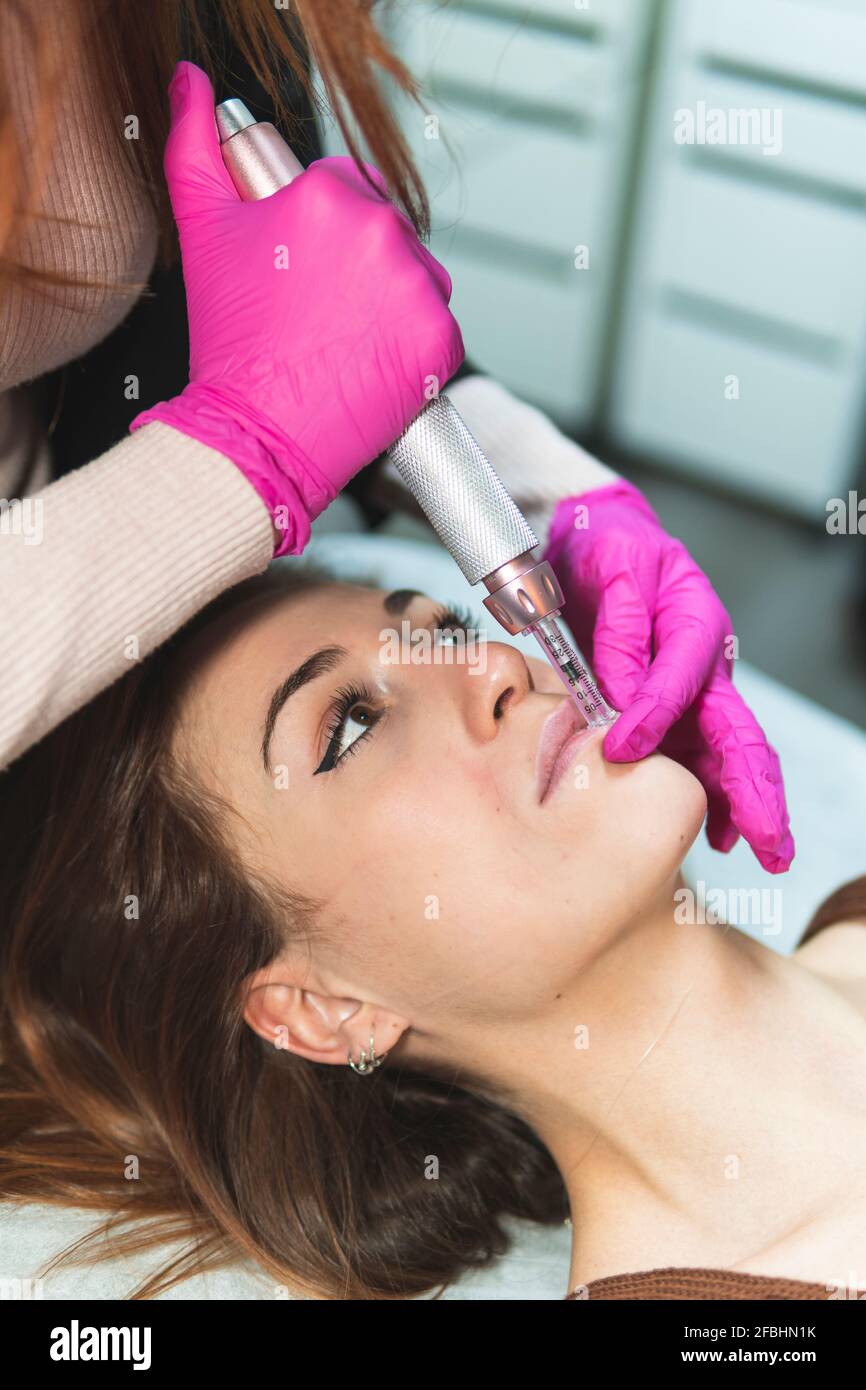 Head of young woman during skin treatment at aesthetic center Stock Photo