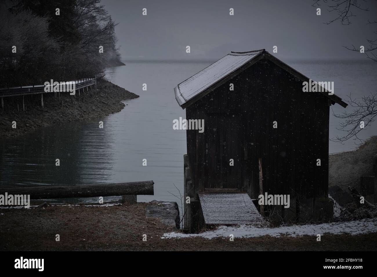 Wooden shack on shore of Lake Walchen at dusk Stock Photo