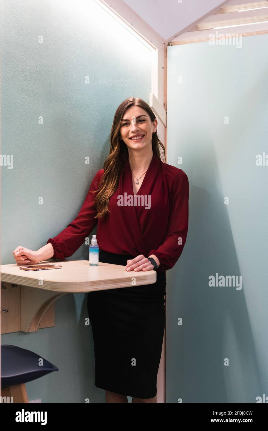 Young female entrepreneur standing at cafeteria Stock Photo