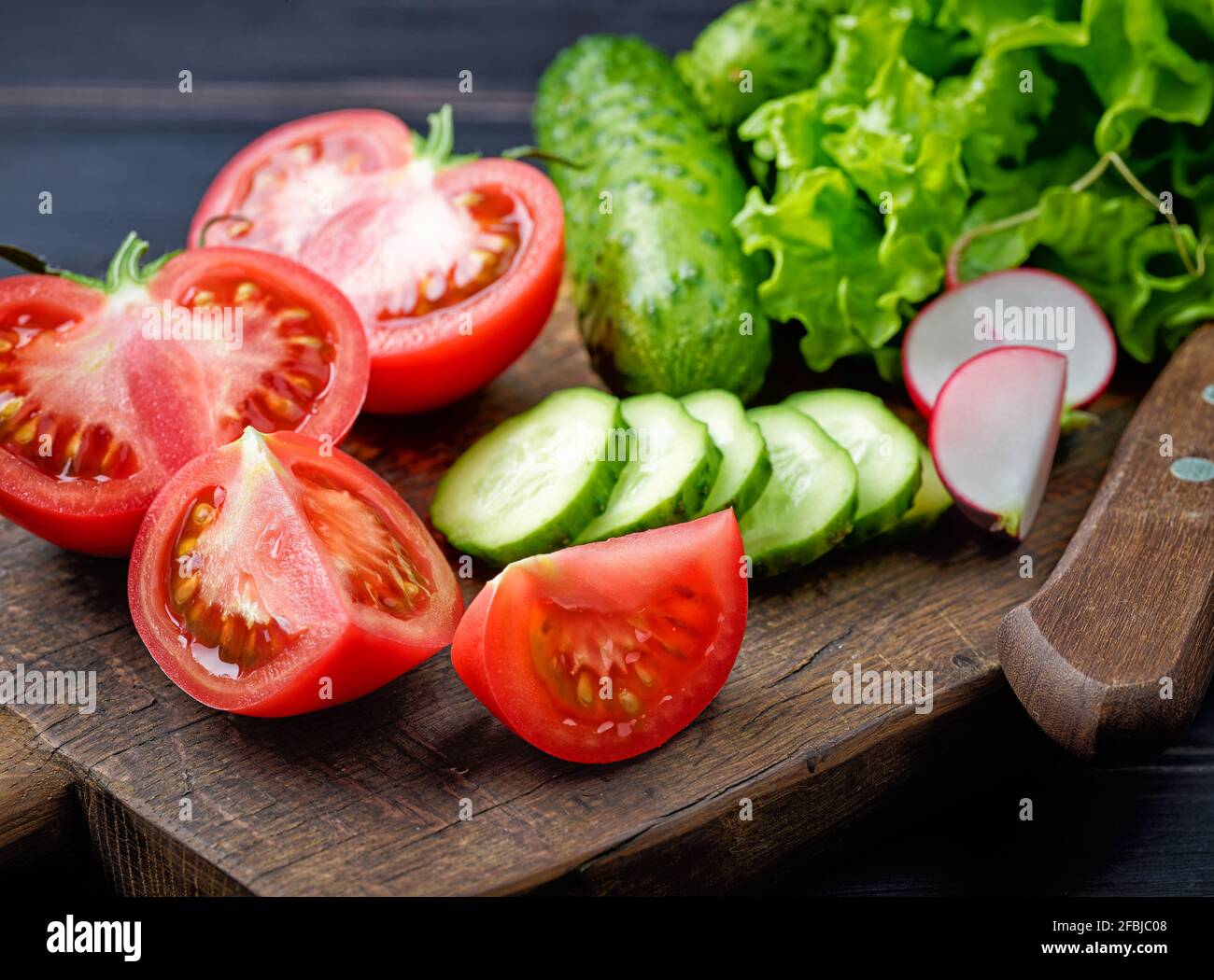 various fresh sliced vegetables on cutting board Stock Photo