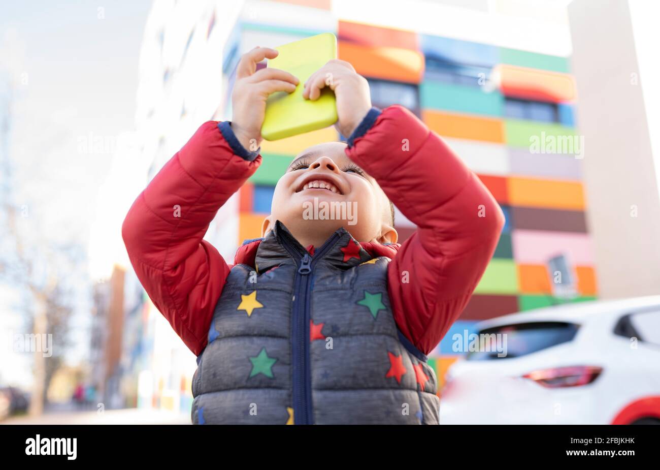 Smiling boy using mobile phone Stock Photo