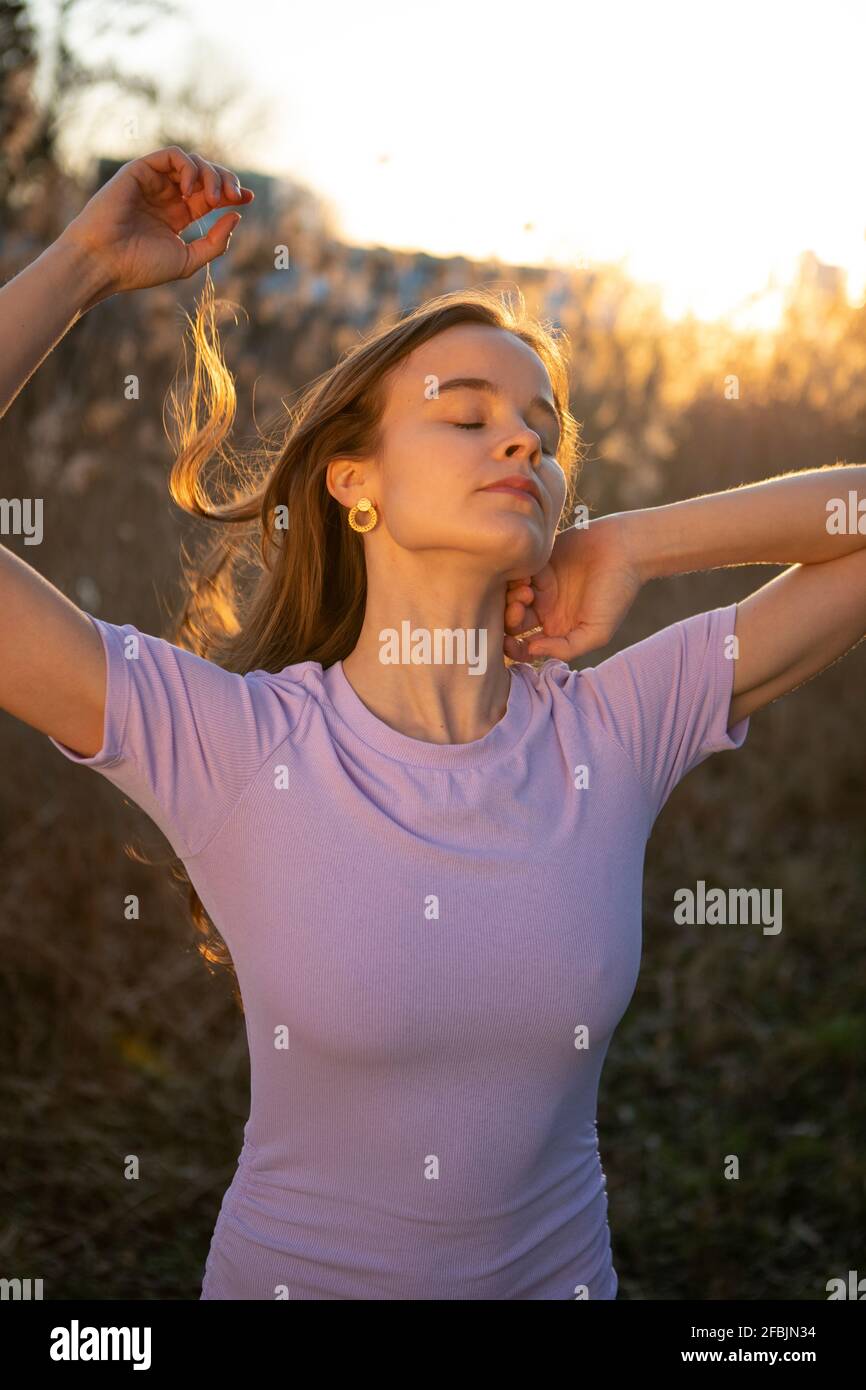 Beautiful woman with eyes closed standing in nature Stock Photo - Alamy
