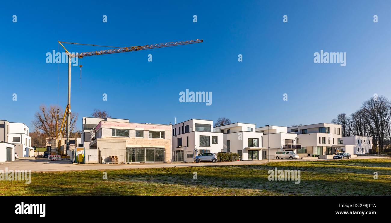Germany, Baden-Wurttemberg, Ludwigsburg, Panorama of clear sky over new modern development area with industrial crane in background Stock Photo