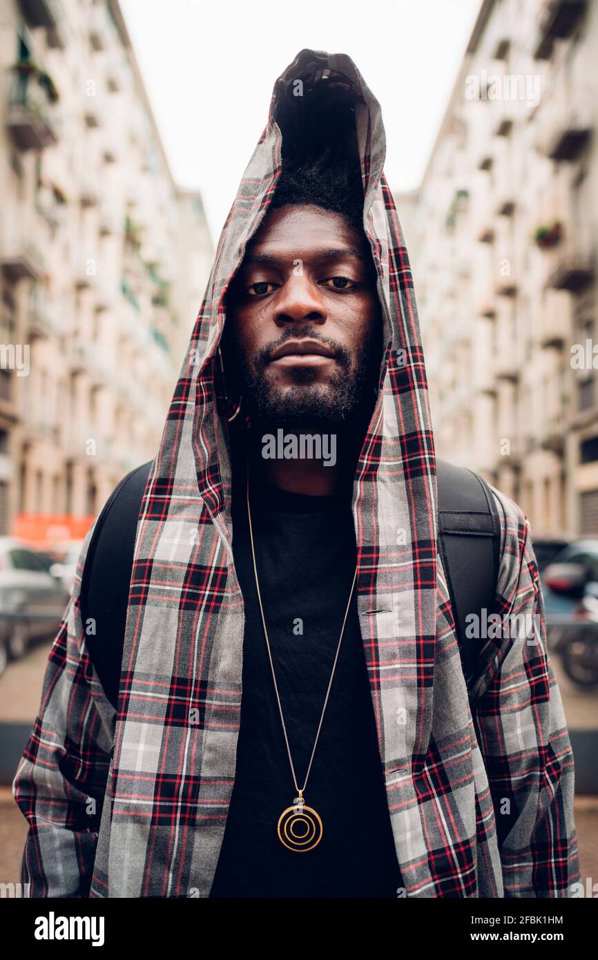 Confident young man in hooded jacket Stock Photo