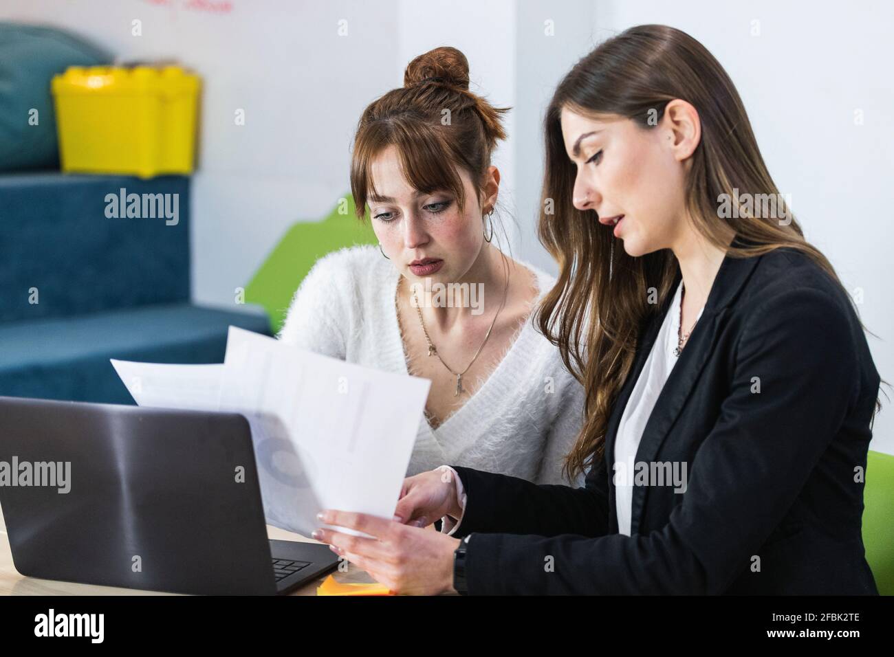 Young entrepreneurs working over document in office Stock Photo