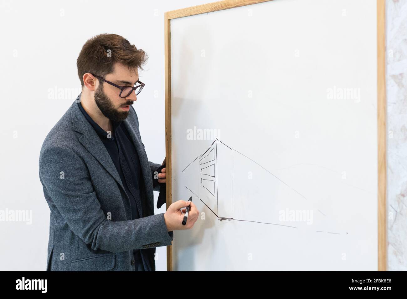 Young businessman drawing diagram on whiteboard Stock Photo
