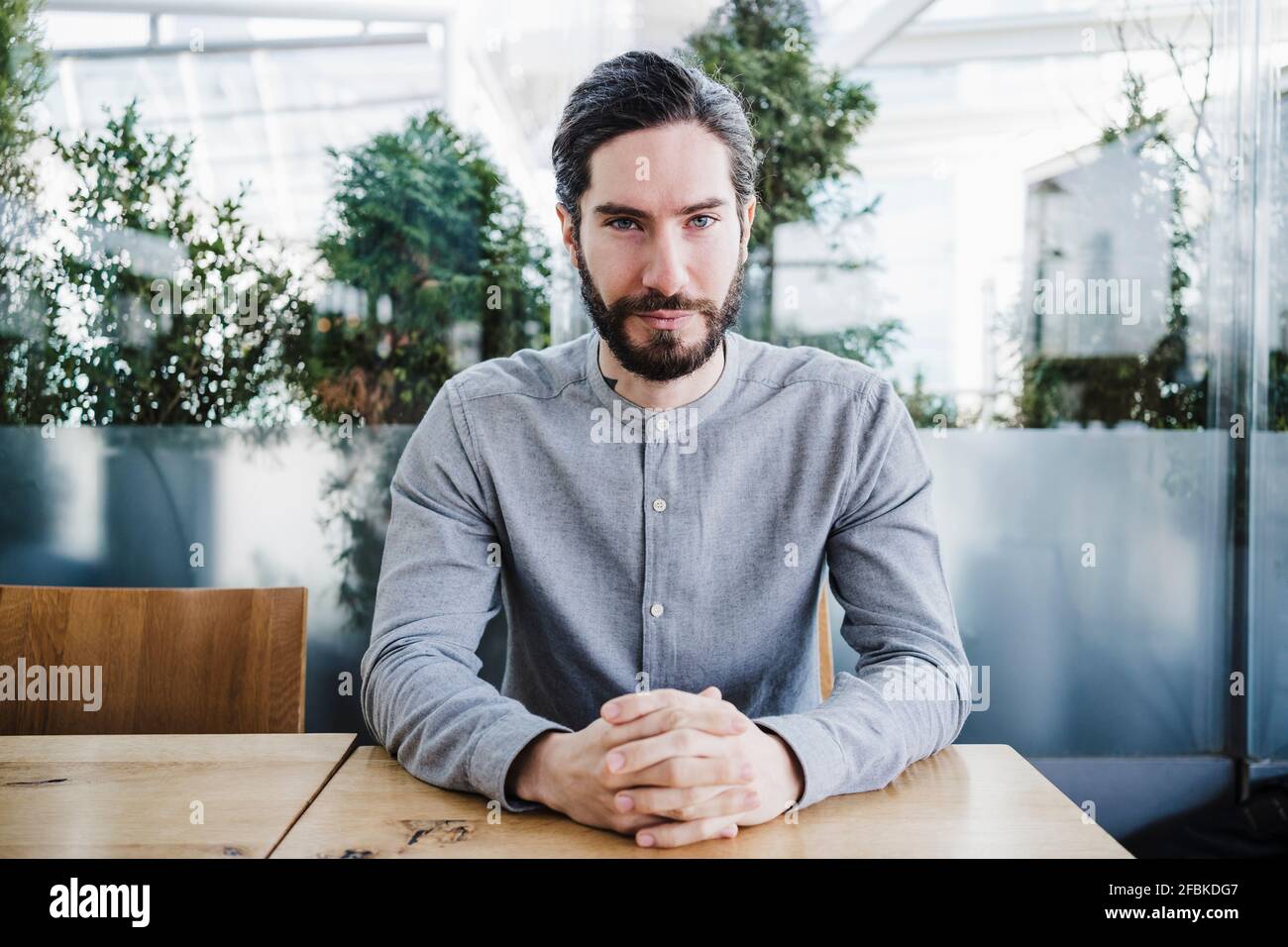 Handsome businessman with gray eyes at work place Stock Photo