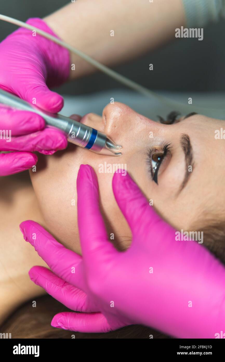 Face of young woman during skin treatment at aesthetic center Stock Photo