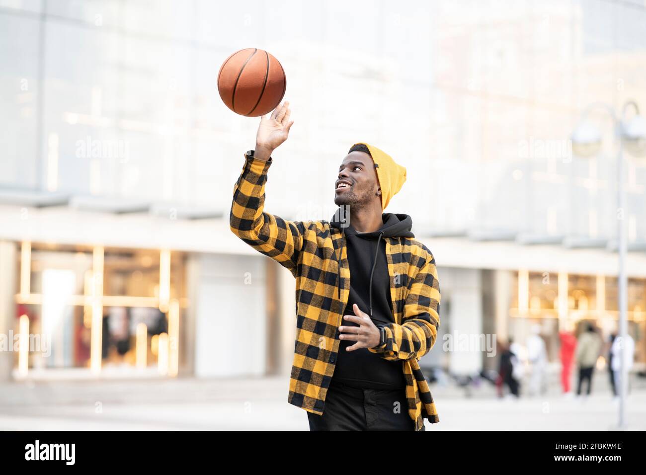 Young African-American man playing with basketball Stock Photo