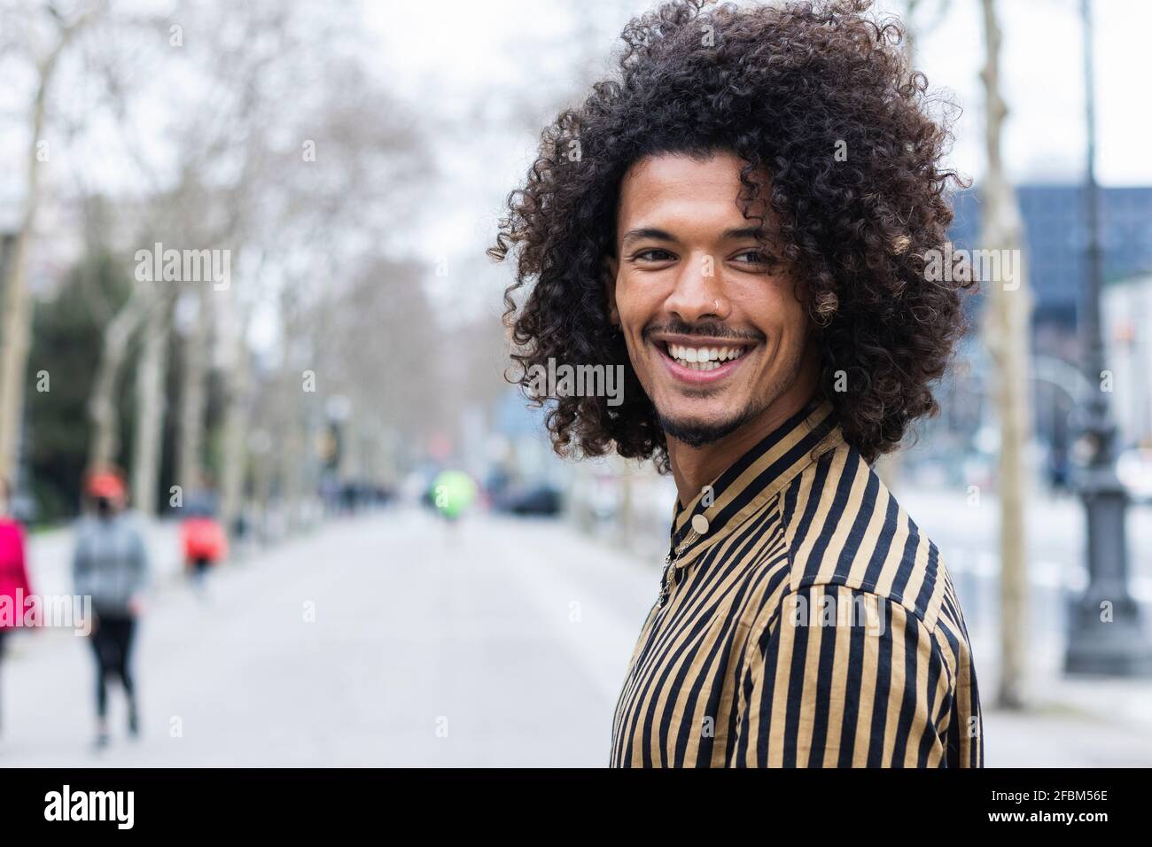 Young man with brown curly hair hi-res stock photography and images - Alamy