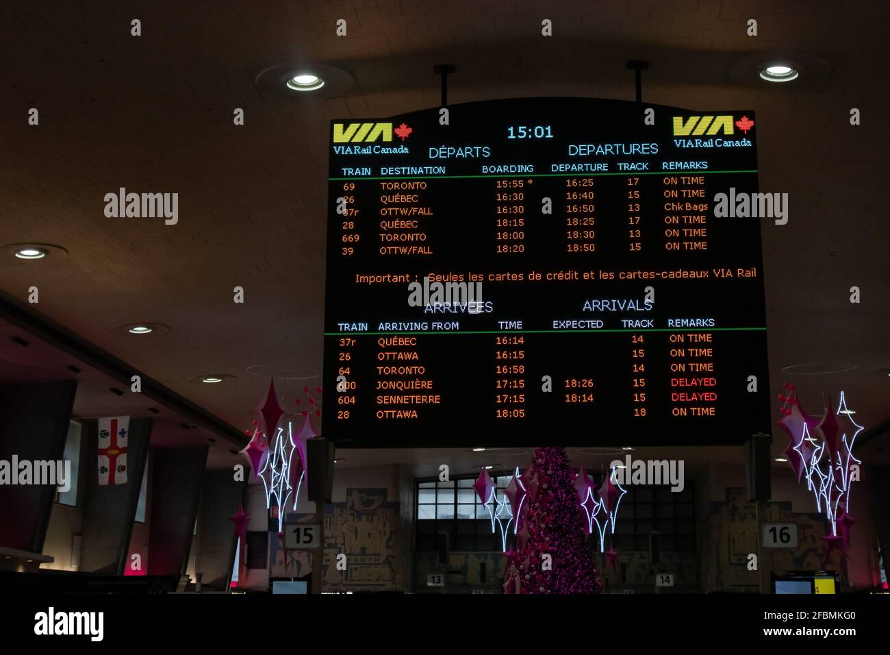 Montreal, Quebec, Canada - 1/2/2020: Electronic sign board hanging in VIA Rail's Central Station in Montreal shows train schedule. Stock Photo