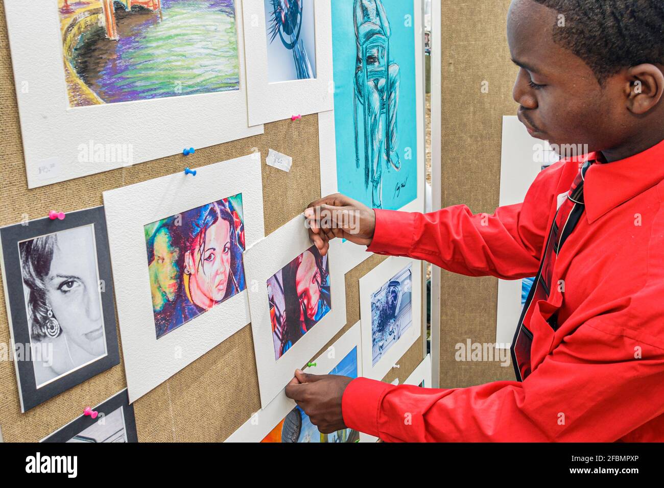 Miami Florida,Coconut Grove Arts Festival,festivals fair event community,Black high school artist boy art student hanging artwork,teen teenage teenage Stock Photo