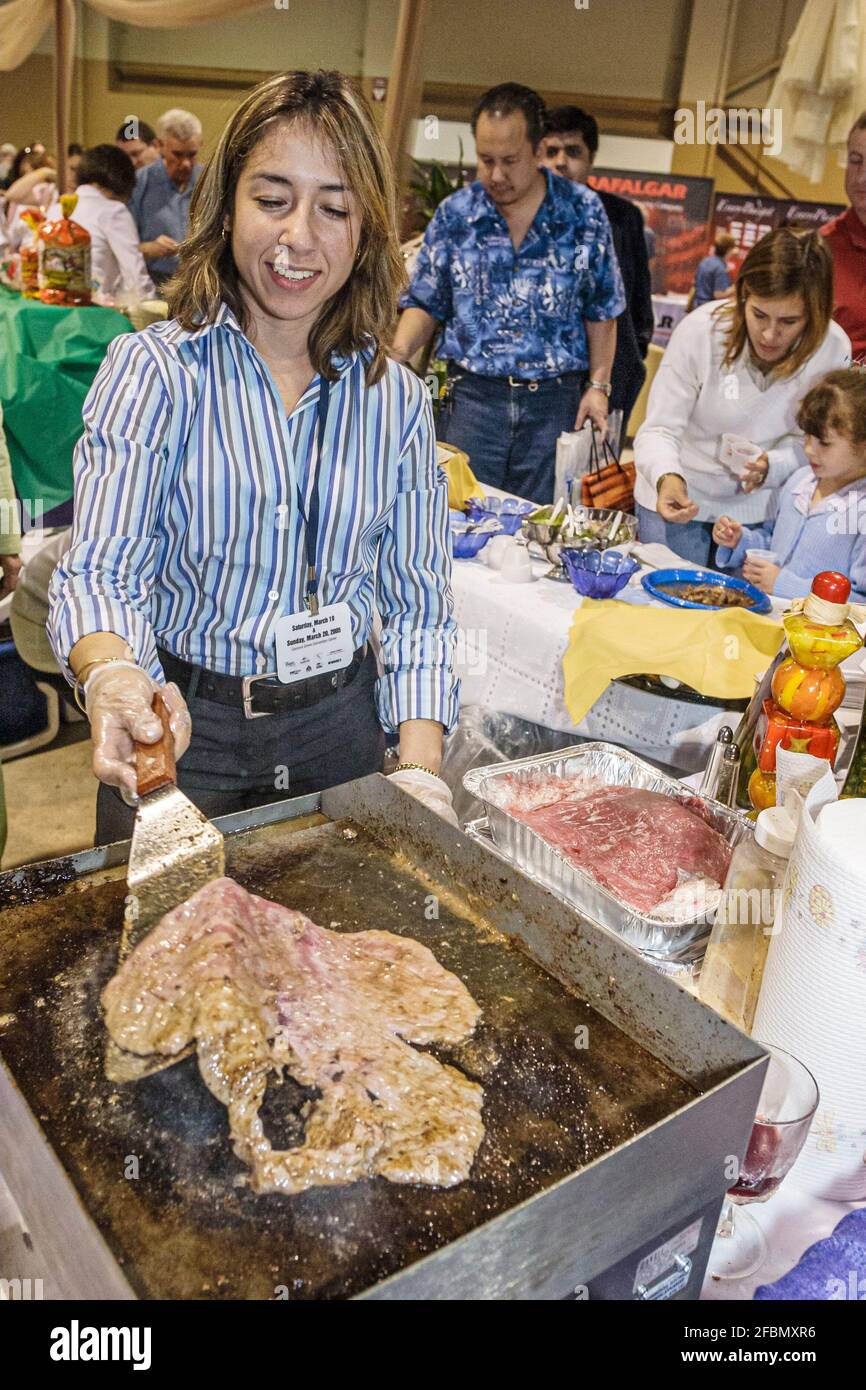 Miami Florida,Coconut Grove Convention Center centre,Miami Herald Travel Expo,Hispanic woman female cooking steak grilling, Stock Photo