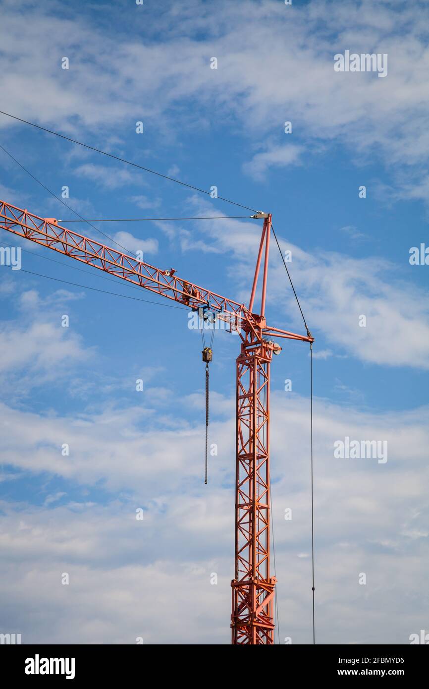 Construction crane against the blue sky with clouds Stock Photo - Alamy