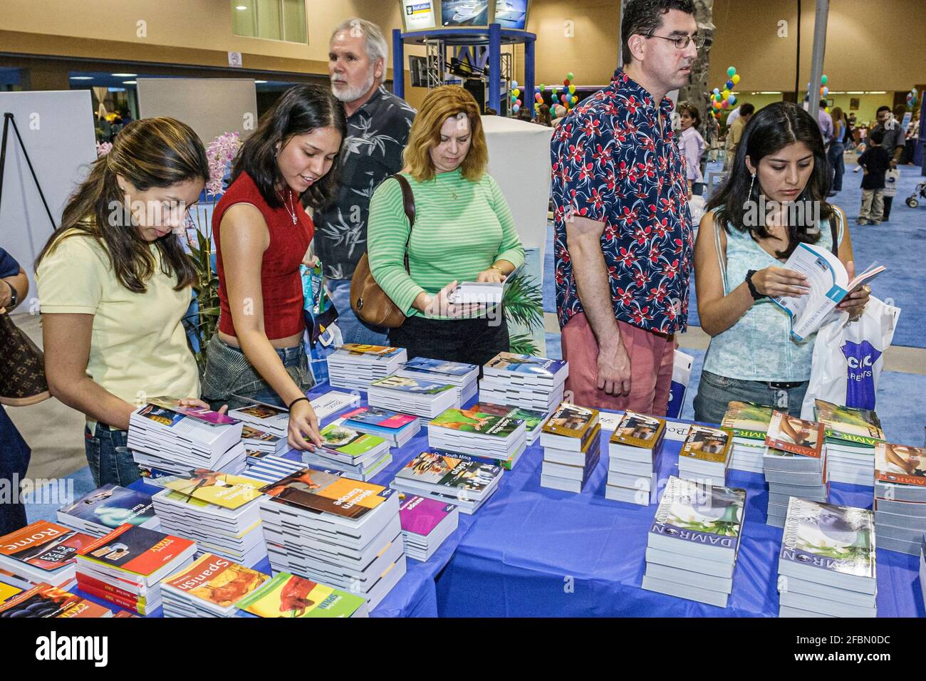 Miami Florida,Coconut Grove Convention Center centre,Miami Herald Travel Expo guidebooks display sale Hispanic women,shoppers shopping, Stock Photo