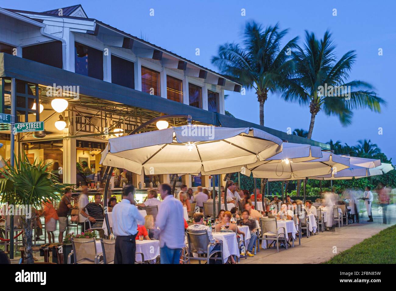 Miami Beach Florida,South Pointe Park Smith & Wollensky restaurant,al fresco sidewalk outside tables umbrellas evening,night evening, Stock Photo